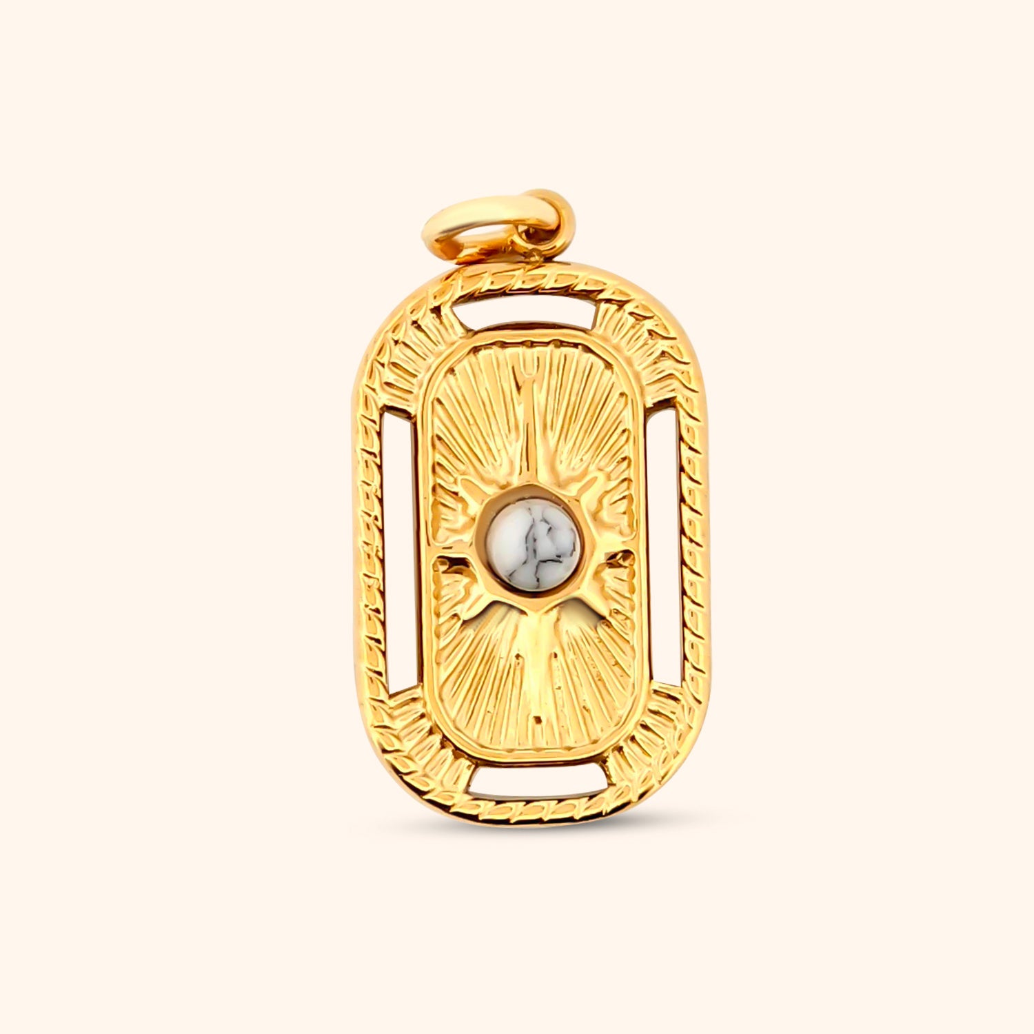 Close-up of the Savanna Charm, a rectangular gold charm featuring intricate star details and a textured border.